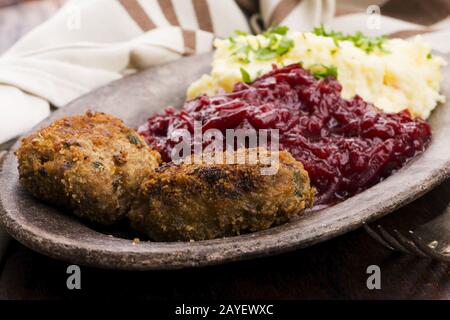 Prepared dinner on the plate. Melted meat, potatoes, beetroot Stock Photo