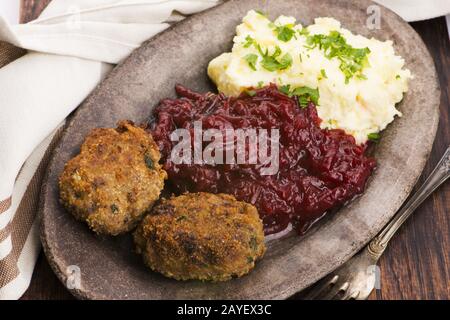 Prepared dinner on the plate. Melted meat, potatoes, beetroot Stock Photo