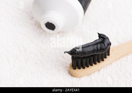 Toothbrush with black charcoal toothpaste Stock Photo