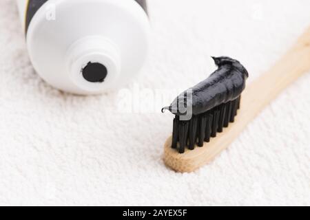 Toothbrush with black charcoal toothpaste Stock Photo