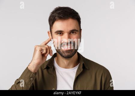 Comfortable and easy use. Attractive bearded modern man, businessman walking city and walking client via wireless earphones, tou Stock Photo
