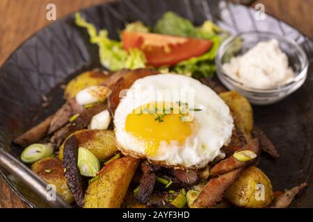 Tyrolean potato grostl in a pan Stock Photo