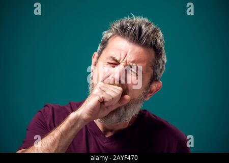 A portrait of bearded yawning bored man in red t-shirt. People and emotions concept Stock Photo