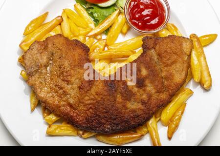 wiener schnitzel with french fries on a plate Stock Photo