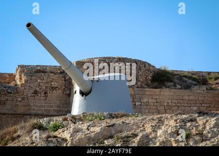 an old discarded cannon from a warship on a rock Stock Photo