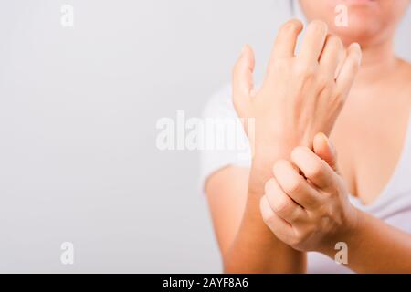 Asian beautiful woman itching her useing hand scratch itch hand on white background with copy space, Medical and Healthcare concept Stock Photo