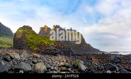 Ruins of Dunluce Castle on the edge of cliff. Filming location of popular TV show. Stock Photo