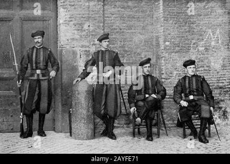 Vintage photo circa late 1915 showing the Vatican Swiss Guard to the Pontifical Holy See stationed at the Vatican. The Papal Swiss Guard are bodyguards within the Vatican. Recruits to the guards must be Catholic, single Swiss citizens and have basic training with the Swiss Armed Forces. Stock Photo