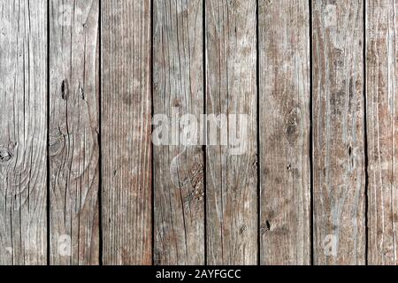 Background of old, weathered, dried-up, vertical wooden planks with deep cracks and knots. intricate pattern. Texture of wood. Free text space. Stock Photo