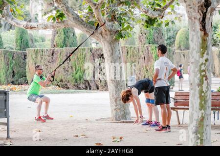 12 JULY 2018, BARCELONA, SPAIN: group of adult friends or sportsmen exercising and workout in Ciutadella park Stock Photo