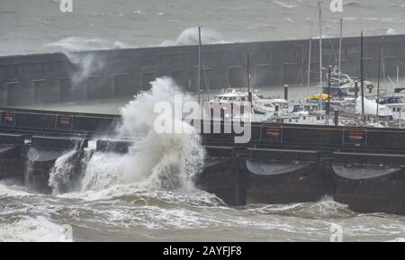 Brighton UK 15th February 2020 - Waves crash over Brighton Marina as Storm Dennis arrives on the South Coast with amber warnings being issued around the country for possible flooding and wind damage over the weekend  . Credit: Simon Dack / Alamy Live News Stock Photo