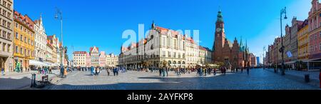 Panoramic view of the medieval Wroclaw Market Square with its colorful houses, old town hall and numerous tourists on a sunny day. Wroclaw, Poland. Stock Photo