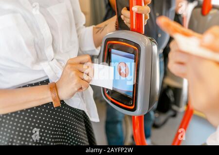 Woman trying to validate electronic ticket in public transport and machine denial to read ticket Stock Photo