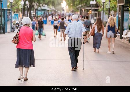 15 JULY 2018, TARRAGONA, SPAIN: Old couple walks on the street Stock Photo