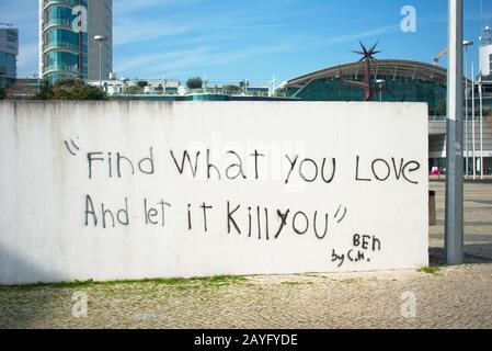 Phrase graffiti written on a concrete wall in Lisbon Stock Photo