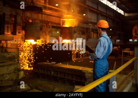 Master steelmaker at furnace, steel factory Stock Photo