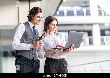Cheerful smiling partners discussing new business project Stock Photo