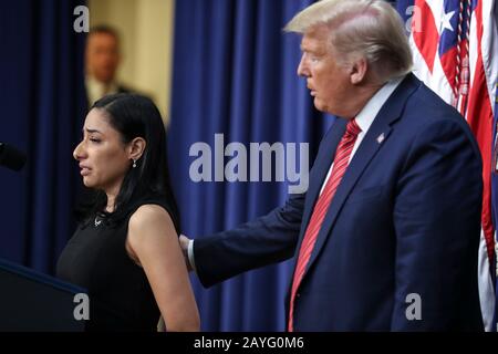 Washington DC, USA. 15th Feb 2020. President Donald Trump tries to comfort Daria Ortiz who recounted the death of her grandmother, allegedly by a man who was living in the country without legal permission, speaks, during a speech to members of the National Border Patrol Council in the South Court Auditorium at the Eisenhower Executive Office Building on the White House complex on February 14, 2020 in Washington, DC. (Photo by Oliver Contreras/SIPA USA) Credit: Sipa USA/Alamy Live News Stock Photo