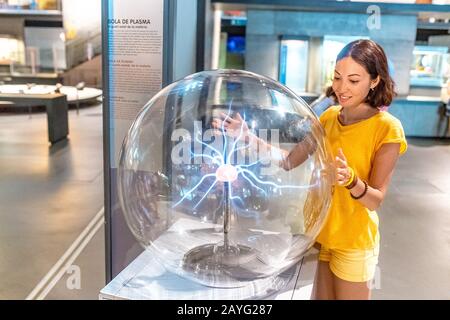28 JULY 2018, BARCELONA, SPAIN: People playing with Plasma Ball in science museum Stock Photo