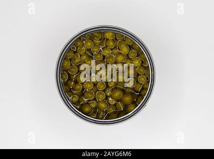 Top view close up on isolated open metal can with green peas, blank white background Stock Photo