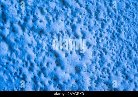 The texture of the porous paint is blue. Natural background. Out of focus, soft focus Stock Photo
