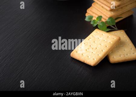 dry salted crackers on granite plate with oregano Stock Photo