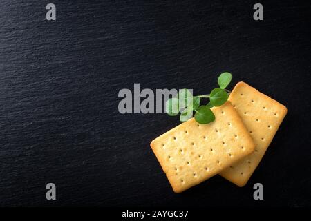 dry salted crackers on granite plate with oregano Stock Photo