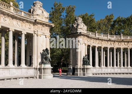 A statue in front of Colonnade at the Alonso XII monument at the Retiro Park, Madrid, Spain Stock Photo