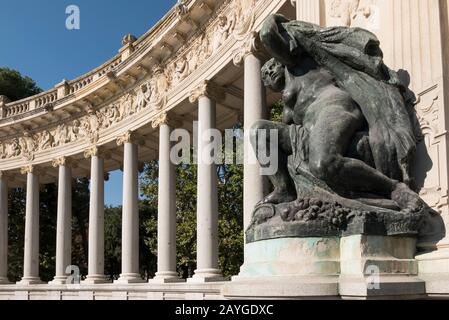 A statue in front of Colonnade at the Alonso XII monument at the Retiro Park, Madrid, Spain Stock Photo