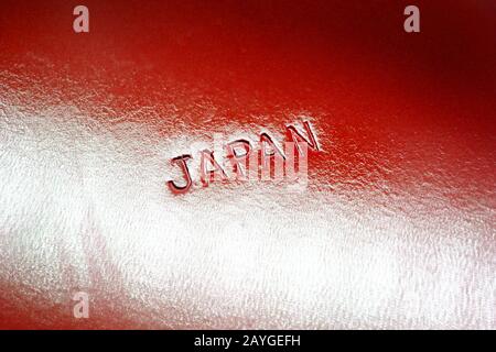 Japan, inscription printed on red plastic surface, close-up Stock Photo