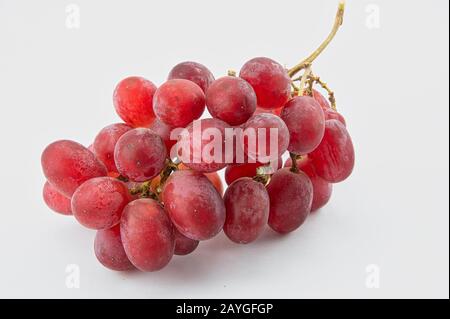 A bunch of red seedless grapes on a white background Stock Photo