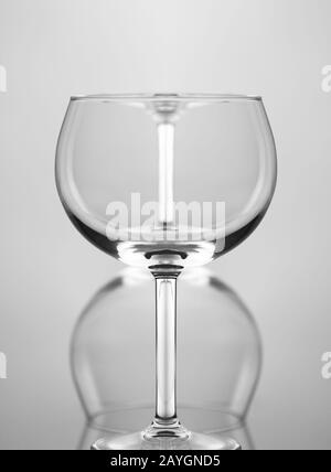 Wine Glass Abstract: Two wine glasses one in front of the other and upside down, against a gray background. Stock Photo