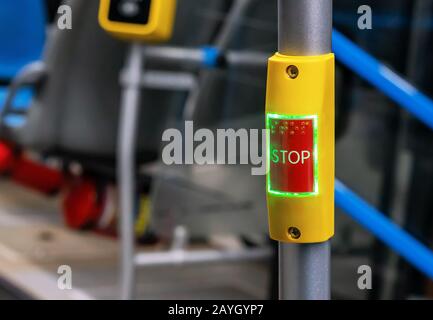 Red stop button in public transport. Bus stop button at the request of the passenger. Stock Photo