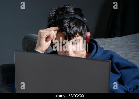 Teenage boy , 13 years of age, watches videos online Stock Photo