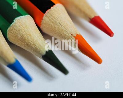 Extreme close of coloured pencil nibs on white paper Stock Photo