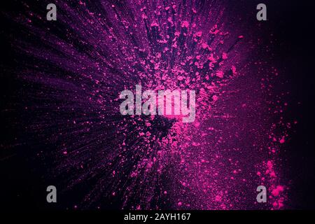 Freeze motion of pink powder exploding, isolated on black, wallpaper with copy space. Stock Photo
