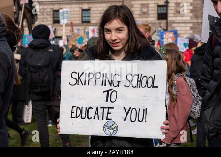 Young girl at a Youth Strike 4 Climate protest in Parliament Square, London, UK. Skipping school to demonstrate for action on global warming Stock Photo