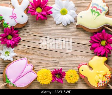 Food frame, Easter cookies on a wooden background, gingerbread in the shape of a rabbit, chicken, flower and bird Stock Photo