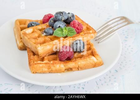 Waffles Raspberries And Custard Stock Photo Alamy