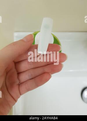 Female fingers with soap dispenser. Top view, closeup Stock Photo