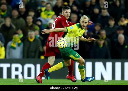 15th February 2020; Carrow Road, Norwich, Norfolk, England, English Premier League Football, Norwich versus Liverpool; Andrew Robertson of Liverpool competes for the ball with Teemu Pukki of Norwich City Stock Photo