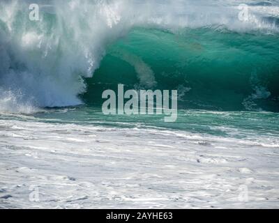 Big waves on the north shore of Oahu with aquamarine seas, white foam and blue skies. Stock Photo