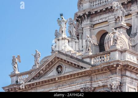 Basilica di Santa Maria della Salute in Venice, Italy. The detail with statues on the facade. Famous church of Salute is one of the main landmarks of Stock Photo