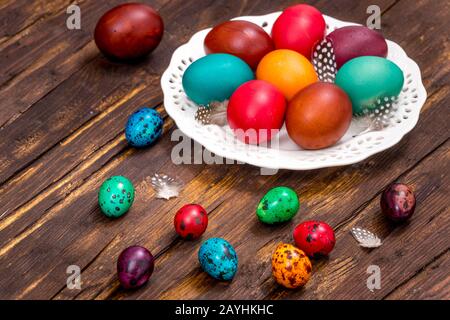 Happy Easter. Traditionally painted quail eggs on a wooden background. Stock Photo