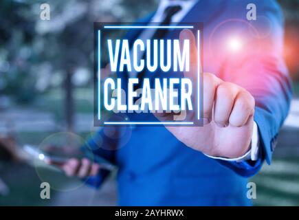 Handwriting text writing Vacuum Cleaner. Conceptual photo machine that cleans floors and surfaces by sucking up dust Businessman with pointing finger Stock Photo