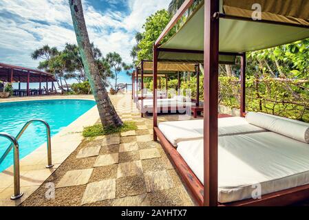 Sri Lanka - November 4, 2017: Swimming pool and beach beds in a tropical hotel