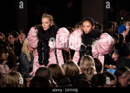 Models on the catwalk for the Richard Quinn show during London Fashion Week February 2020 at Lawrence Hall in London. Stock Photo