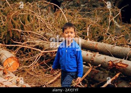 Bishkek, Kyrgyzstan - April 9, 2019: International mointain day. A little boy smiles at the camera. Homeless little child Stock Photo