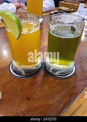 two glasses of seaweed and passion fruit beer on a table Stock Photo