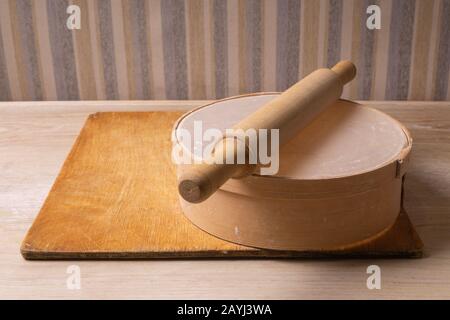 Plywood cutting board, wooden flour sieve and wooden rolling pin - tools for making dough Stock Photo